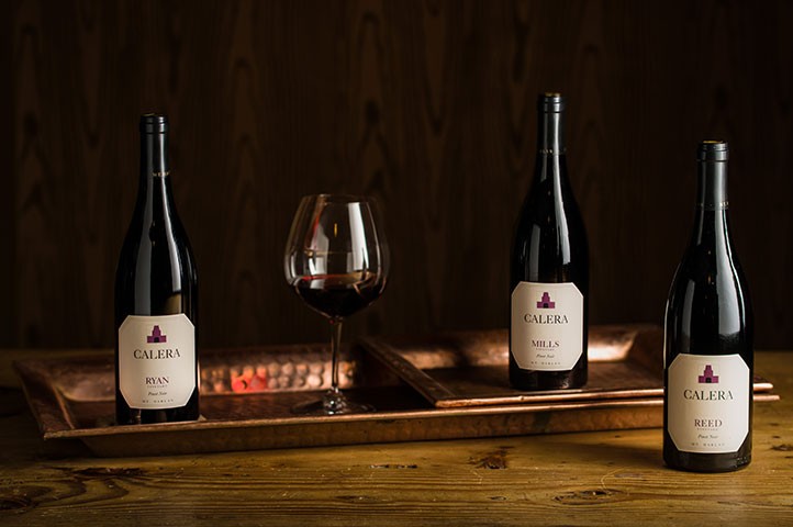 Library bottles of Calera on dark wood counter