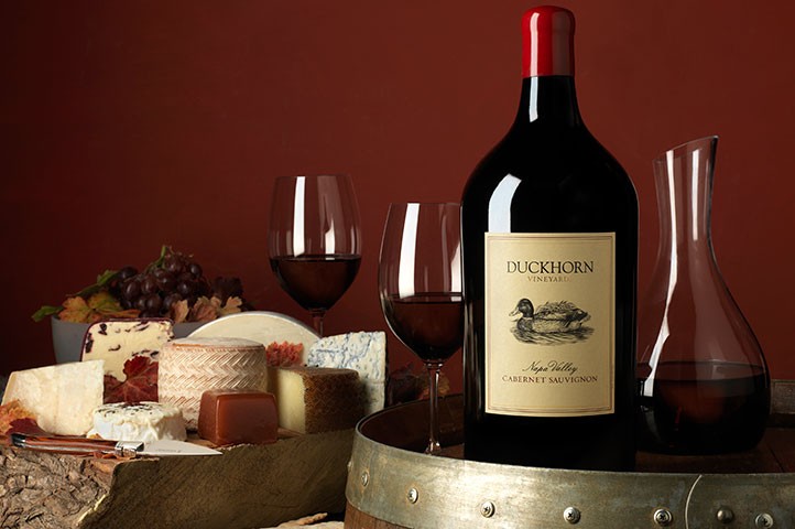 Duckhorn Cabernet magnum on a barrel with cheese