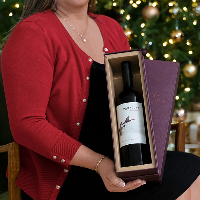 A Paraduxx red wine being opened by a lady