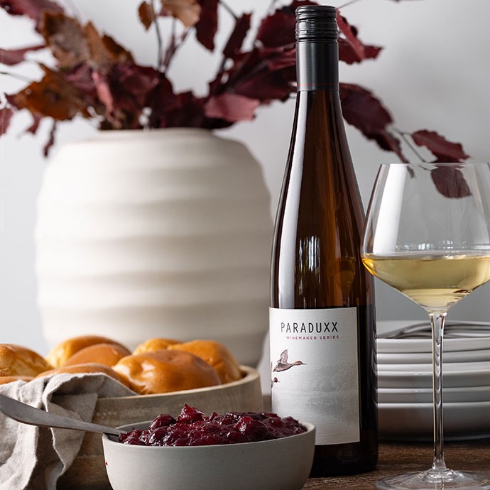Paraduxx white wine bottle on a picnic blanket