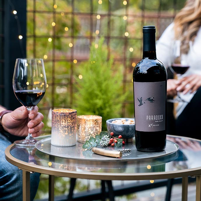 2017 Paraduxx X2 Napa Valley Red Wine on a table being enjoyed by a couple