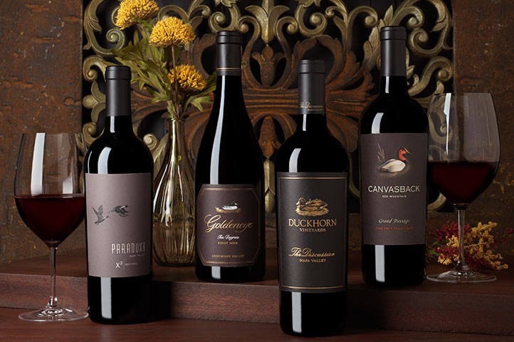 four pinnacle wines with two glasses of wine